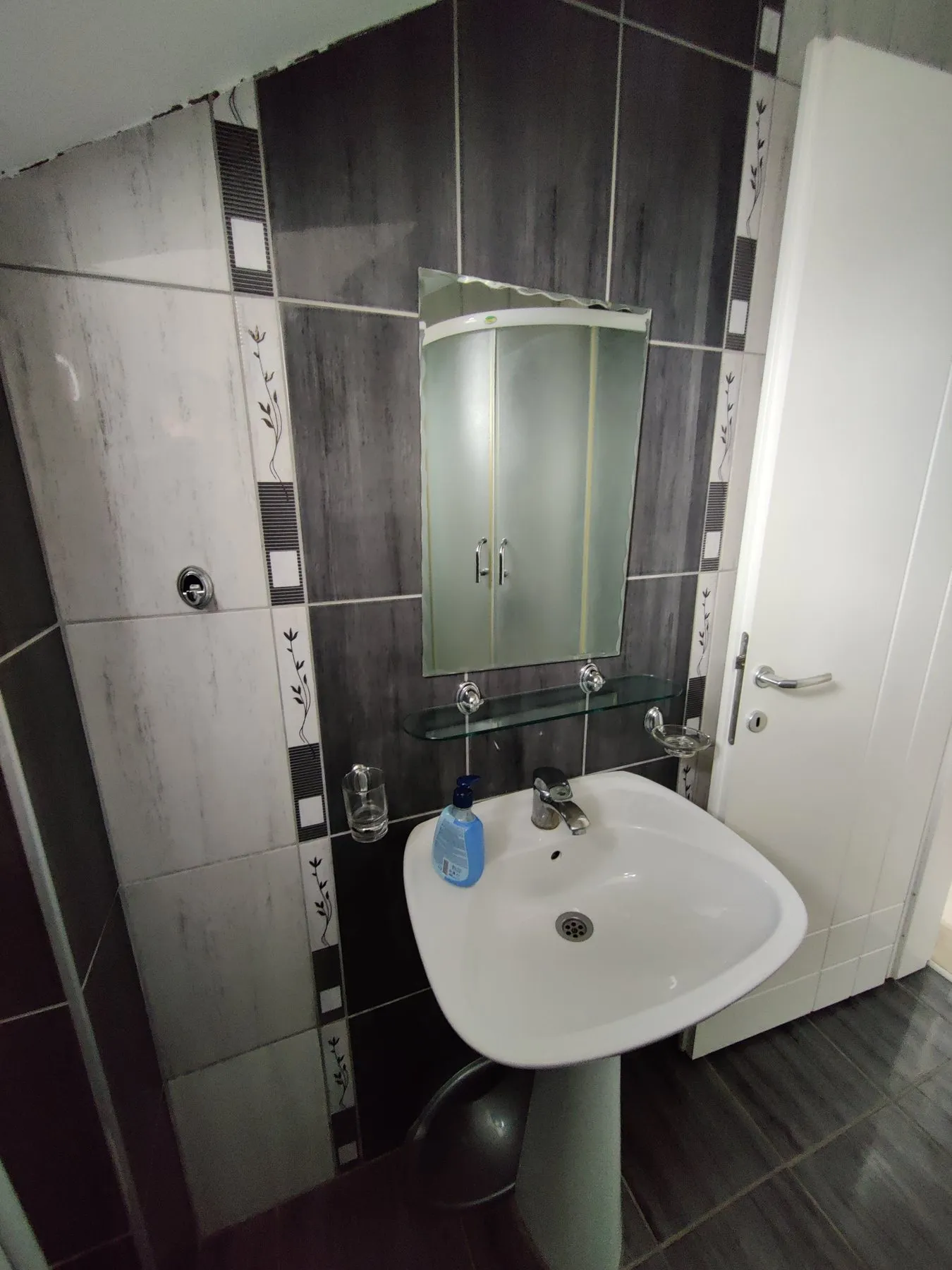 Bathroom in the Duplex Apartment with a shower, sink, and toilet